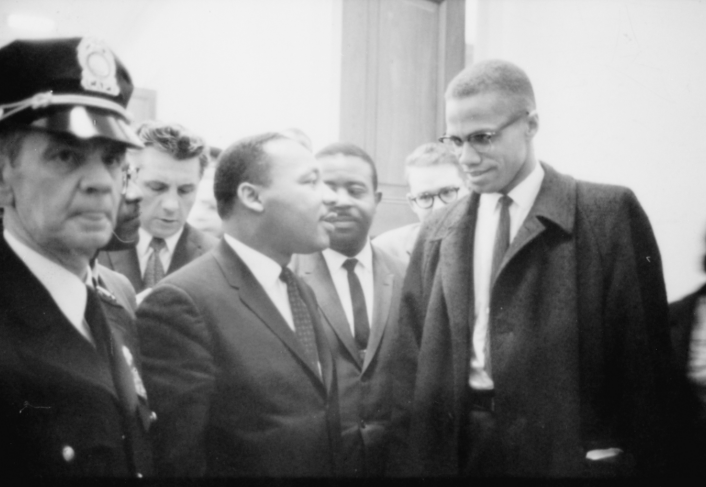 Malcolm X and Martin Luther King Have a Conversation While Surrounded by Fellow Activists and Members of the Press