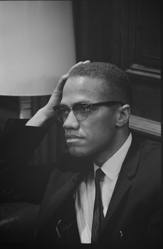 Malcolm X sitting